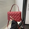 Deep red quilted crossbody bag with gold buckle and geometric stitching details - Red