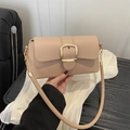 Chic beige underarm baguette bag featuring a prominent gold square buckle and chain strap - Khaki