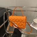 Fashionable bright orange quilted crossbody bag with a sleek metal trim and top handle - Orange Red