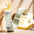 Detail of Eid money pull box featuring dollar-style stickers with gold crescent moon patterns - White Money Pulling Box / White