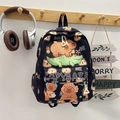 Detail of cute black capybara print school backpack hanging on a wooden wall hook - Black