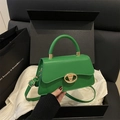 Minimalist green leather crossbody bag with golden V-shaped clasp in a gift box - Green