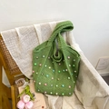 Grass green crochet tote bag with colorful pearl embellishments on a wooden chair - Green
