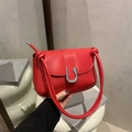 Minimalist red leather shoulder bag featuring a decorative silver U-shaped metal buckle - Red