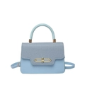 Minimalist light blue crossbody bag with textured fabric flap and gold metal hardware - Blue