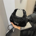 Black crescent shoulder bag with pleated texture and silver metal bow detail - Black