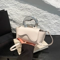 Cream white crossbody bag with silver sculptural round handle and wavy flap design - White
