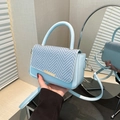 Light blue crossbody bag featuring a stylish woven herringbone pattern on the front flap - Blue