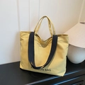 Gelbe Vintage Canvas-Einkaufstasche mit schwarzen Trägern und modischem Aufdruck - Khaki