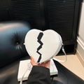 White heart-shaped crossbody bag with black lightning print and silver zipper detail - White