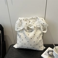 White pleated tote bag with black floral embroidery and Magic Pocket brand tag - White