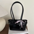 Minimalist black tote bag with bow detail and silver buckles in stylish patent finish - Black