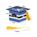 Detail view of striped graduation cap favor box with dimensions 9x6x14cm and yellow tassel - Blue
