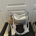Silver metallic pillow handbag with knotted strap and cute brown teddy bear keychain - Standard Type / Silver