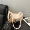Pink glossy leather pillow bag with cute plush bear charm and knotted strap handle - Pink