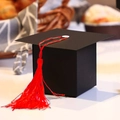 Black graduation cap favor box with a bright red tassel for party candy and gifts - Red