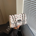 White crossbody bag with red cherry prints and black metal chain strap buckle - White