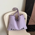 Lavender minimalist canvas tote bag featuring black FANYISSA lettering on the side - Purple