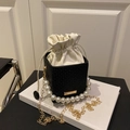 Woven black and white bucket bag with pearl handle and golden chain strap - Black