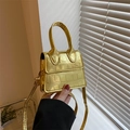 Metallic gold mini crossbody bag with crocodile embossed pattern and top handle - Gold