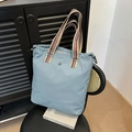 Light blue canvas tote bag with multi-color striped handles and spacious interior - Blue