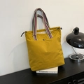 Ginger yellow canvas tote bag with striped handles and geometric floral logo design - Dark Yellow