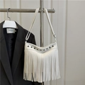White pebbled leather shoulder bag featuring vintage studs and long fringe detail - White