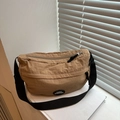 Close-up of a light brown crescent nylon bag with a Lucky Fashion logo badge - Khaki