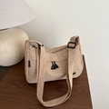 Fashionable beige nylon crossbody bag with dual front zippers on a wooden table - Khaki