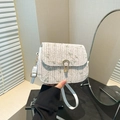 Woven straw crossbody bag featuring green and pink floral embroidery and a gold horseshoe buckle - White