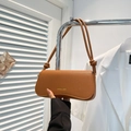 Minimalist brown pebbled leather shoulder bag with knotted straps and gold logo detail - Brown