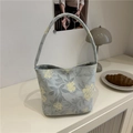 Light blue floral canvas tote bag with yellow flower prints in a cozy cafe setting - Green