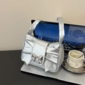 Silver metallic pleated handbag with a large bow detail and stylish mirror finish - Silver