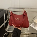 Chic red faux leather shoulder bag with gold bow clasp and decorative knotted handle - Red