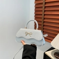 Light blue bow handbag with silver glitter finish and wavy edge design - Silver