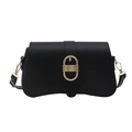 Minimalist black leather crossbody bag with vintage golden oval textured buckle on white background - Black