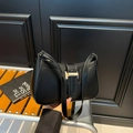 Minimalist black faux leather shoulder bag with decorative gold-tone hardware - Black
