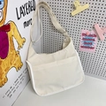 Minimalist cream nylon crossbody bag with two front pockets and adjustable strap - White
