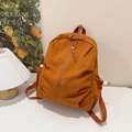 Minimalist caramel nylon backpack with side drawstring pockets and durable zippers - Orange