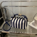 Blue and white striped canvas crossbody bag with navy leather straps and gold metal lock - Blue