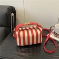 Red and white striped canvas handbag with leather handle and golden metal clasp lock - Red