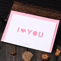 Elegant laser-cut I LOVE YOU greeting card with pink envelope on a wooden table - Love You Design (308# loyou)