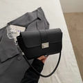 Minimalist black matte leather baguette bag with a silver buckle and thin shoulder strap - Black