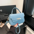 Elegant light blue mini Kelly-style crossbody bag with gold-tone hardware and top handle - Blue