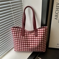 Classic red and white houndstooth tote bag with burgundy leather handles on a window sill - Red