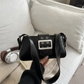Chic black underarm bag in matte leather featuring a bold silver buckle and metal eyelets - Black