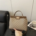 Chic brown leather and beige monogram handbag with a gold metal clasp and top handle - Khaki