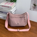 Versatile nylon crossbody bag in dusty pink with multiple practical zipper compartments - Pink