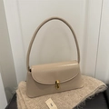 Minimalist beige glossy leather underarm bag with gold metal clasp on knit fabric - Khaki