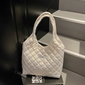 Quilted white tote bag with glossy finish and Fashion Instinct label on stairs - Off White